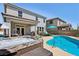 Expansive backyard featuring a pool, hot tub, covered patio, and outdoor seating for entertaining and relaxation at 9625 W Meranto Ave, Las Vegas, NV 89178