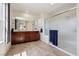 Bathroom with double vanity, large mirror and a glass shower enclosure at 9625 W Meranto Ave, Las Vegas, NV 89178