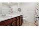 Bathroom featuring single vanity, coordinating shower curtain and updated lighting at 9625 W Meranto Ave, Las Vegas, NV 89178
