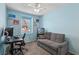 Bedroom with cool blue paint, a sofa, desk, and fish tank, creating a comfortable retreat at 9625 W Meranto Ave, Las Vegas, NV 89178