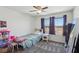 Bedroom with two windows, ceiling fan, gray carpet, and decor at 9625 W Meranto Ave, Las Vegas, NV 89178