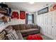 Relaxing bedroom with a sectional sofa and sports decor, offering a comfortable space for relaxation and entertainment at 9625 W Meranto Ave, Las Vegas, NV 89178