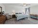 Bright bedroom with ceiling fan, neutral carpet and comfortable furnishings at 9625 W Meranto Ave, Las Vegas, NV 89178