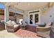 Relaxing covered patio with comfortable seating, a ceiling fan, and ambient lighting at 9625 W Meranto Ave, Las Vegas, NV 89178