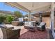 Cozy covered patio area with comfortable seating, perfect for relaxing and enjoying the backyard at 9625 W Meranto Ave, Las Vegas, NV 89178