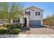 Charming two-story home with a brick driveway and lush desert landscaping at 9625 W Meranto Ave, Las Vegas, NV 89178