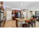 Stylish kitchen island with granite countertops, bar seating, and a view to the dining area and living room at 9625 W Meranto Ave, Las Vegas, NV 89178