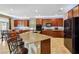 Kitchen with an island featuring bar stool seating, stainless steel appliances, and ample cabinet space at 9625 W Meranto Ave, Las Vegas, NV 89178