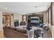 Open-concept living room with tile flooring and a modern entertainment center at 9625 W Meranto Ave, Las Vegas, NV 89178