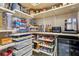 Well-stocked pantry with pull out shelving, small appliances and ample storage space at 9625 W Meranto Ave, Las Vegas, NV 89178