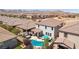 Aerial view of a backyard with a refreshing pool, covered patio, and desert landscaping at 9625 W Meranto Ave, Las Vegas, NV 89178