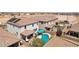 View of a backyard featuring a pool, desert landscaping and covered patio at 9625 W Meranto Ave, Las Vegas, NV 89178