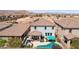 Aerial view of a backyard oasis featuring a pool, desert landscaping and covered patio at 9625 W Meranto Ave, Las Vegas, NV 89178