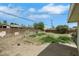 Expansive backyard featuring a partial grass lawn with mature trees and surrounded by a wooden fence at 1041 E Saint Louis Ave, Las Vegas, NV 89104