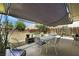 Backyard area featuring an outdoor dining setup and landscaping at 1041 E Saint Louis Ave, Las Vegas, NV 89104