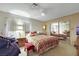 Bedroom with large mirrored closet, window with curtains, and fan light at 1041 E Saint Louis Ave, Las Vegas, NV 89104