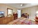 Bedroom with plaid bedspread, electric fireplace, and dresser at 1041 E Saint Louis Ave, Las Vegas, NV 89104