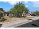 A single-story home with mature trees and desert landscaping enhancing its curb appeal at 1041 E Saint Louis Ave, Las Vegas, NV 89104