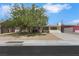 Quaint single-story house with mature trees and desert landscaping enhancing curb appeal at 1041 E Saint Louis Ave, Las Vegas, NV 89104