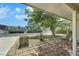 A covered front patio with brick pavers and a large shade tree offers a peaceful outdoor space at 1041 E Saint Louis Ave, Las Vegas, NV 89104