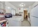 Bright kitchen features white cabinetry, a breakfast bar, and essential appliances for convenient meal preparation at 1041 E Saint Louis Ave, Las Vegas, NV 89104