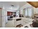 Functional kitchen area with lots of natural light, white appliances, and an open layout leading to the living space at 1041 E Saint Louis Ave, Las Vegas, NV 89104