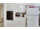 This kitchen includes white cabinets, countertop appliances, and an oven for all your cooking and storage needs at 1041 E Saint Louis Ave, Las Vegas, NV 89104