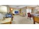 Spacious living room area with carpet flooring, a mounted TV, and a comfortable seating arrangement at 1041 E Saint Louis Ave, Las Vegas, NV 89104