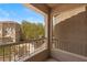 A sunny balcony with white railing overlooking trees and neighborhood buildings at 10550 W Alexander Rd # 2017, Las Vegas, NV 89129