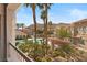 Balcony view showcasing a beautiful pool, palm trees, mountain views, and surrounding community at 10550 W Alexander Rd # 2017, Las Vegas, NV 89129