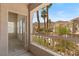 A door to a sunny balcony provides views of the neighborhood pool and community at 10550 W Alexander Rd # 2017, Las Vegas, NV 89129