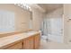 Well-lit bathroom features a vanity with a sink, a toilet, and a shower-tub combination at 10550 W Alexander Rd # 2017, Las Vegas, NV 89129