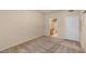 Neutral carpeted bedroom showing attached bathroom through open doorway at 10550 W Alexander Rd # 2017, Las Vegas, NV 89129