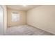 Neutral carpeted bedroom features large window, base trim and ample lighting at 10550 W Alexander Rd # 2017, Las Vegas, NV 89129