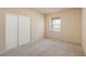 Neutral bedroom features carpet, closet with sliding doors, and bright window at 10550 W Alexander Rd # 2017, Las Vegas, NV 89129