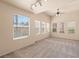 Spacious bedroom with neutral carpet, six windows, ceiling fan, and track lighting at 10550 W Alexander Rd # 2017, Las Vegas, NV 89129