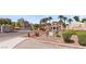 Welcoming entrance to Chateau Versailles with lush landscaping, elegant architecture, and mature palm trees at 10550 W Alexander Rd # 2017, Las Vegas, NV 89129