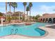 Resort-style community pool featuring lush landscaping and comfortable lounge areas at 10550 W Alexander Rd # 2017, Las Vegas, NV 89129