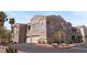 Beautiful building exterior with private garages, lush plantings and ample parking at 10550 W Alexander Rd # 2017, Las Vegas, NV 89129