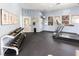 Gym features modern equipment, television, weights, and educational images at 10550 W Alexander Rd # 2017, Las Vegas, NV 89129
