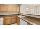 Efficient kitchen with ample countertop space, light wood cabinets, and a view of the living area at 10550 W Alexander Rd # 2017, Las Vegas, NV 89129