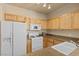 Functional kitchen with white appliances, wooden cabinets and ample counter space at 10550 W Alexander Rd # 2017, Las Vegas, NV 89129