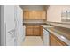 Well-maintained kitchen featuring light wood cabinets and white appliances at 10550 W Alexander Rd # 2017, Las Vegas, NV 89129