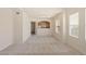 Open-concept living room offers neutral carpet, natural light, and easy kitchen access at 10550 W Alexander Rd # 2017, Las Vegas, NV 89129