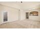 Well-lit living room boasts neutral walls, carpet, and a glass door for outdoor access at 10550 W Alexander Rd # 2017, Las Vegas, NV 89129