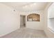 Bright, carpeted living room features an open layout with a view into the kitchen at 10550 W Alexander Rd # 2017, Las Vegas, NV 89129