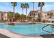 Outdoor pool area with palm trees, various seating options and raised spa at 10550 W Alexander Rd # 2017, Las Vegas, NV 89129