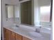 Bathroom vanity featuring double sinks and a large framed mirror at 1160 Golf Club, Laughlin, NV 89029