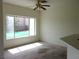 Sunlit bedroom with a ceiling fan and big window view at 1160 Golf Club, Laughlin, NV 89029