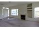 Open living room with bright windows and a cozy fireplace at 1160 Golf Club, Laughlin, NV 89029